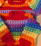 Rainbow coloured jumper for four to five year old children 