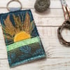 Up cycled embroidered sun keyring or bag charm. 