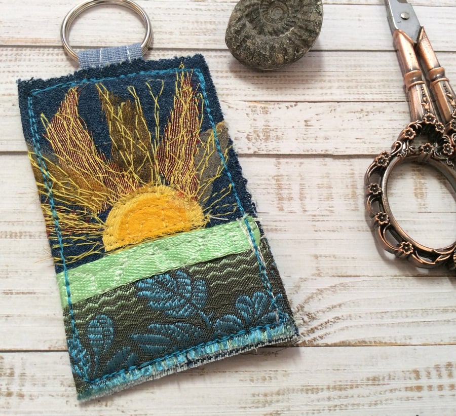 Up cycled embroidered sun keyring or bag charm. 