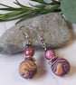Handmade dangly polymer clay earrings in a colourful swirl design - Image 2