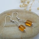 silver plated earrings with retangle shaped amber bead with rounded edges