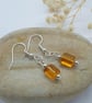 silver plated earrings with retangle shaped amber bead with rounded edges