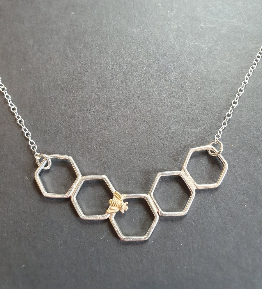 Gold bee on a honeycomb