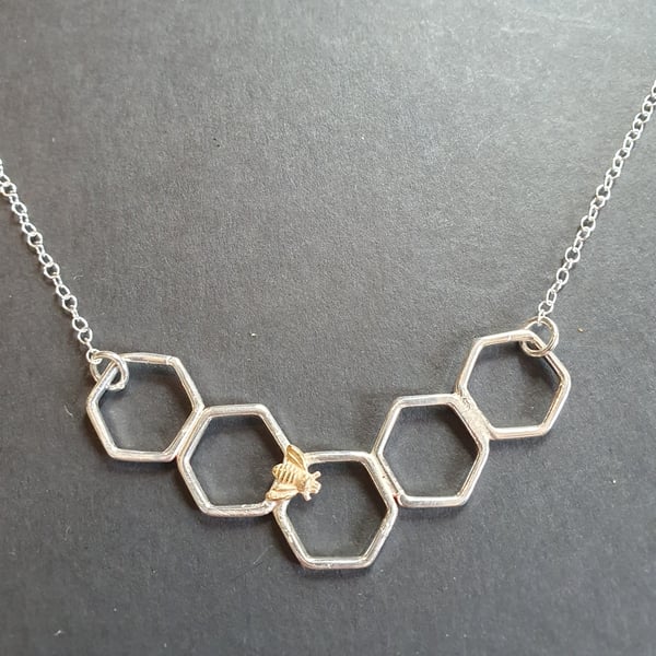 Gold bee on a honeycomb