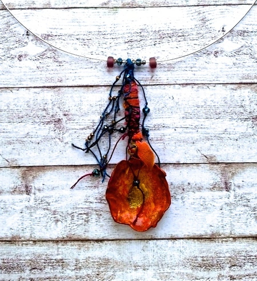 Orange spoon polymer pendant.