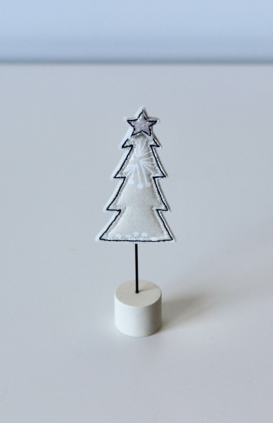 A Little Christmas Tree on a Painted Wooden Stand