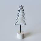 A Little Christmas Tree on a Painted Wooden Stand