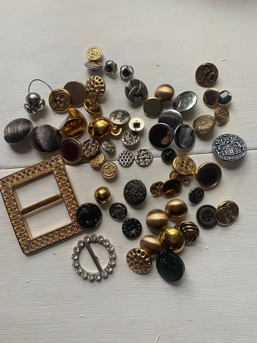 An assorted collection of over fifty vintage metallic  buttons 