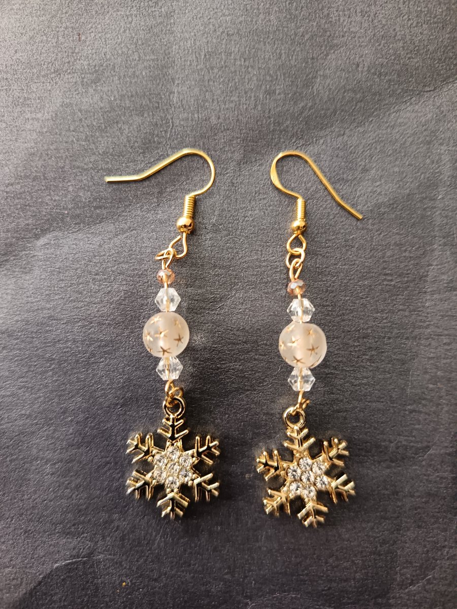 Beaded gold snowflake charm dangle earrings 