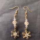 Beaded gold snowflake charm dangle earrings 