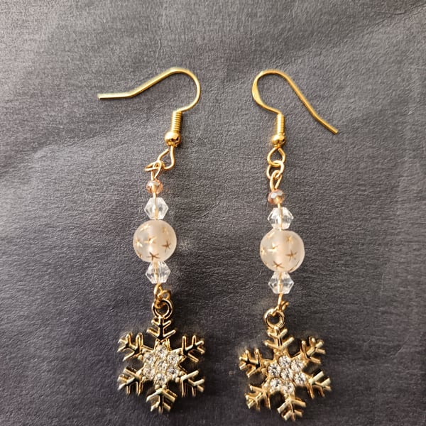 Beaded gold snowflake charm dangle earrings 