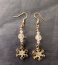 Beaded gold snowflake charm dangle earrings 