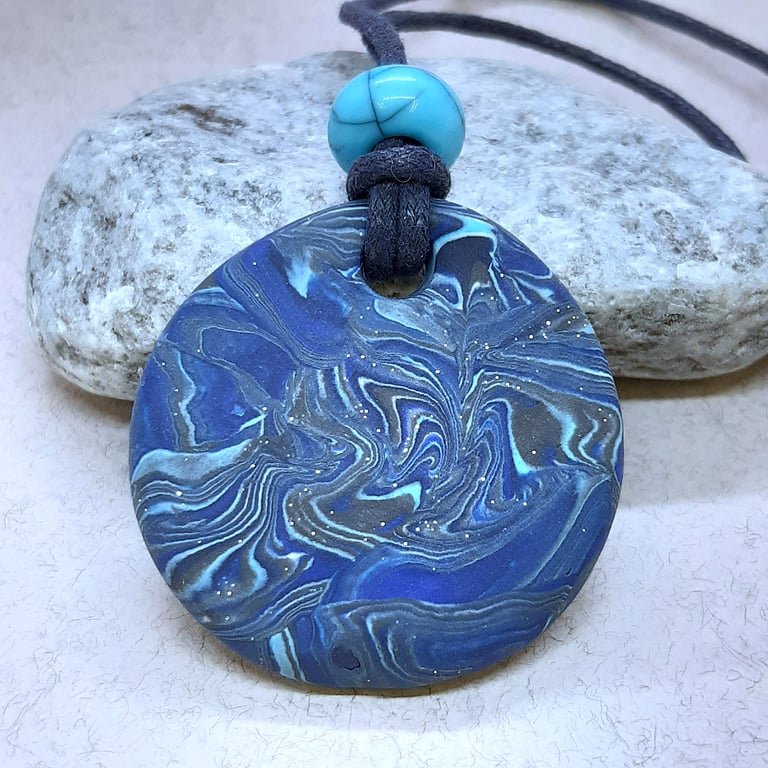 Round blue polymer clay pendant