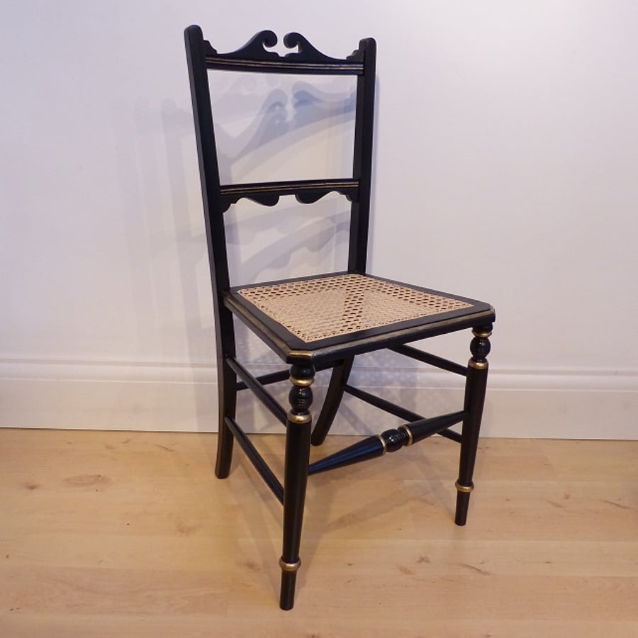 Antique chair in black satin and gold paint