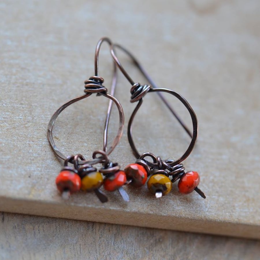 Handmade copper hoop style earrings with red and mustard Czech beads