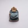 Little ceramic bird cage brooch with flower. Pottery jewellery