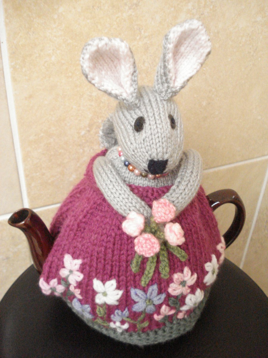 Hand Knitted Pretty Rabbit Cosy With Flowers And Necklace
