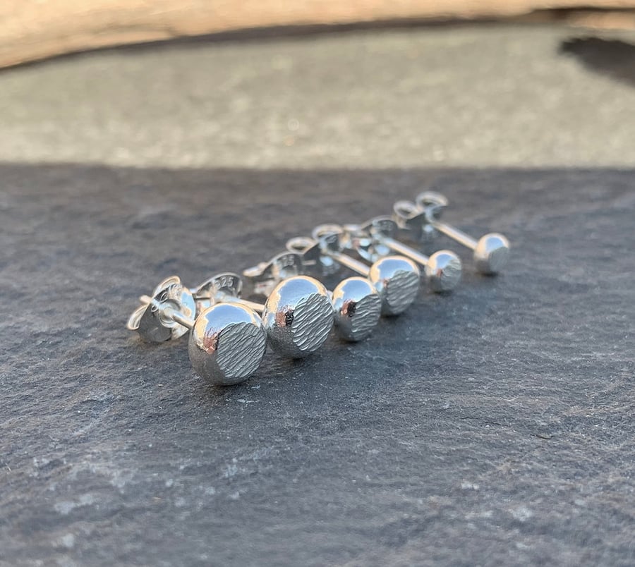 Hammer textured stud earrings, made from recycled silver.