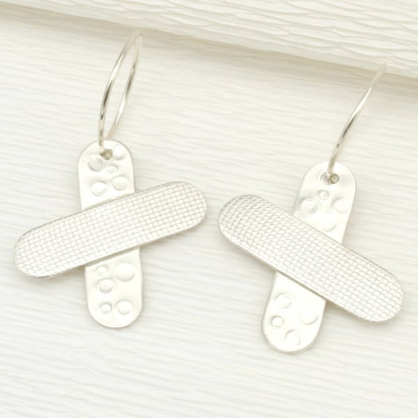 Handmade sterling silver earrings with a satin matt finish and cross shapes.
