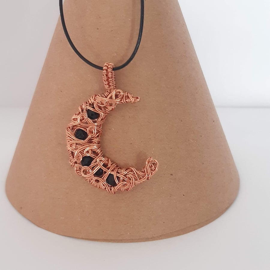 Free form copper crescent moon shaped pendant with gemstones