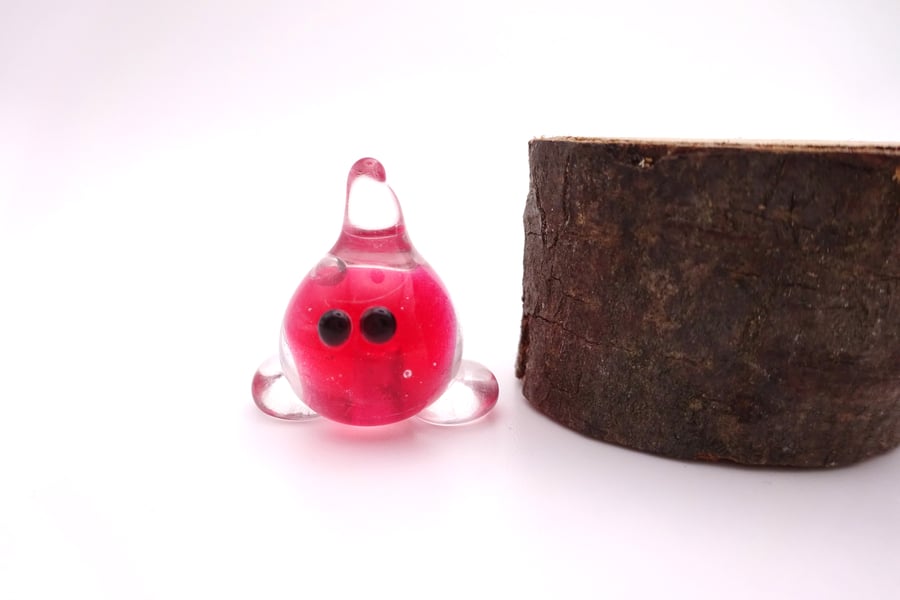 small red glass wisp figure