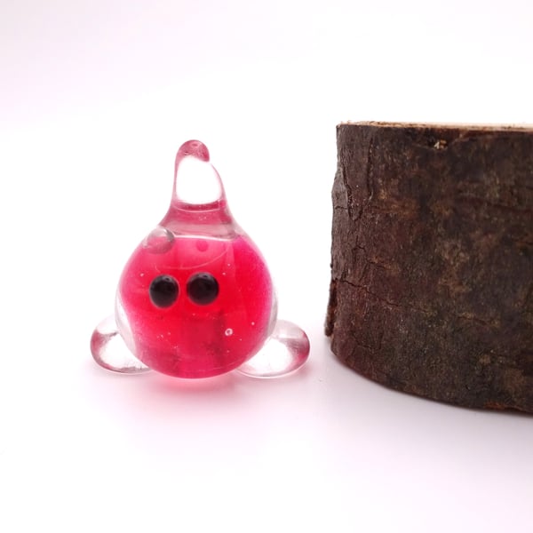 small red glass wisp figure