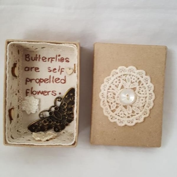 small miniature art diorama with a message 'butterflies are self propelled......