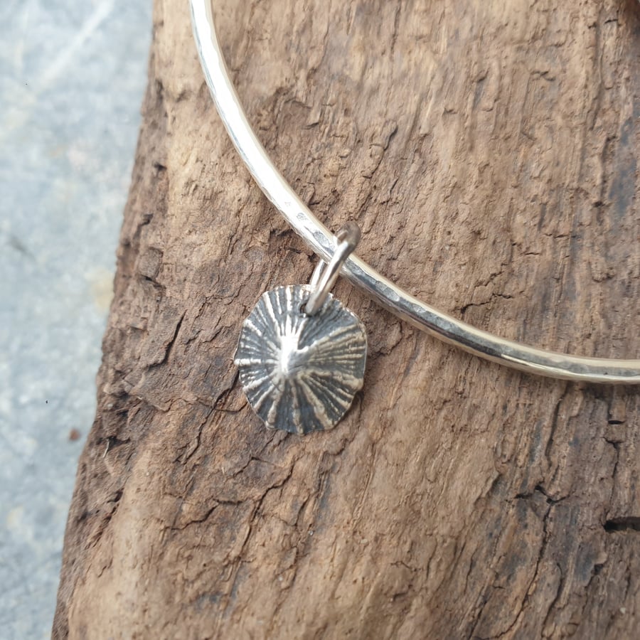 Sterling silver textured bangle with limpet shell charm