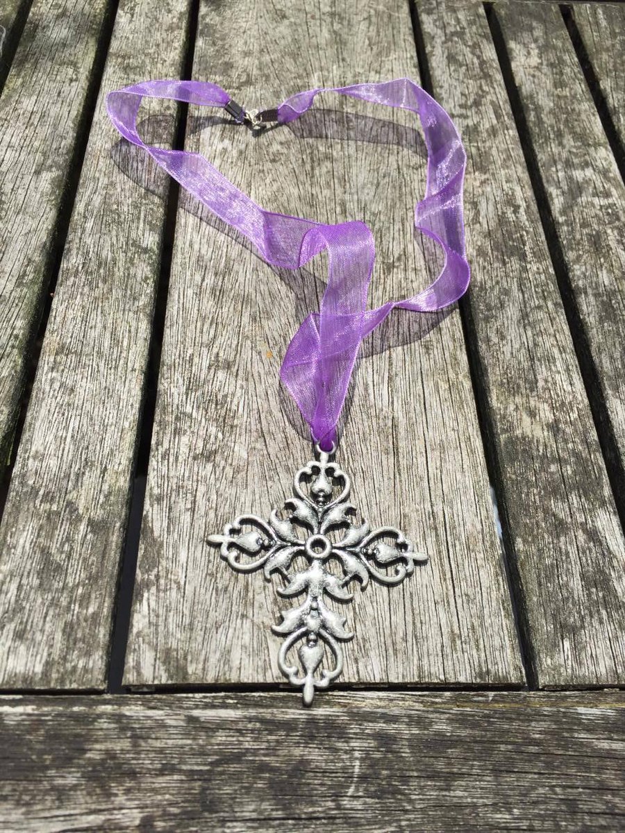 Metal detailed cross on purple ribbon necklace
