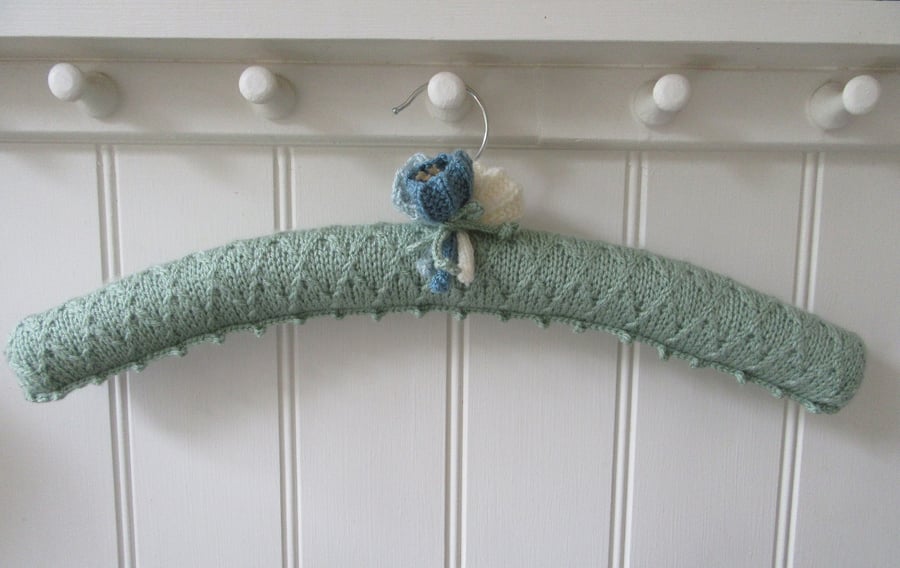 Knitted padded green trellis coat hanger with crocus flowers