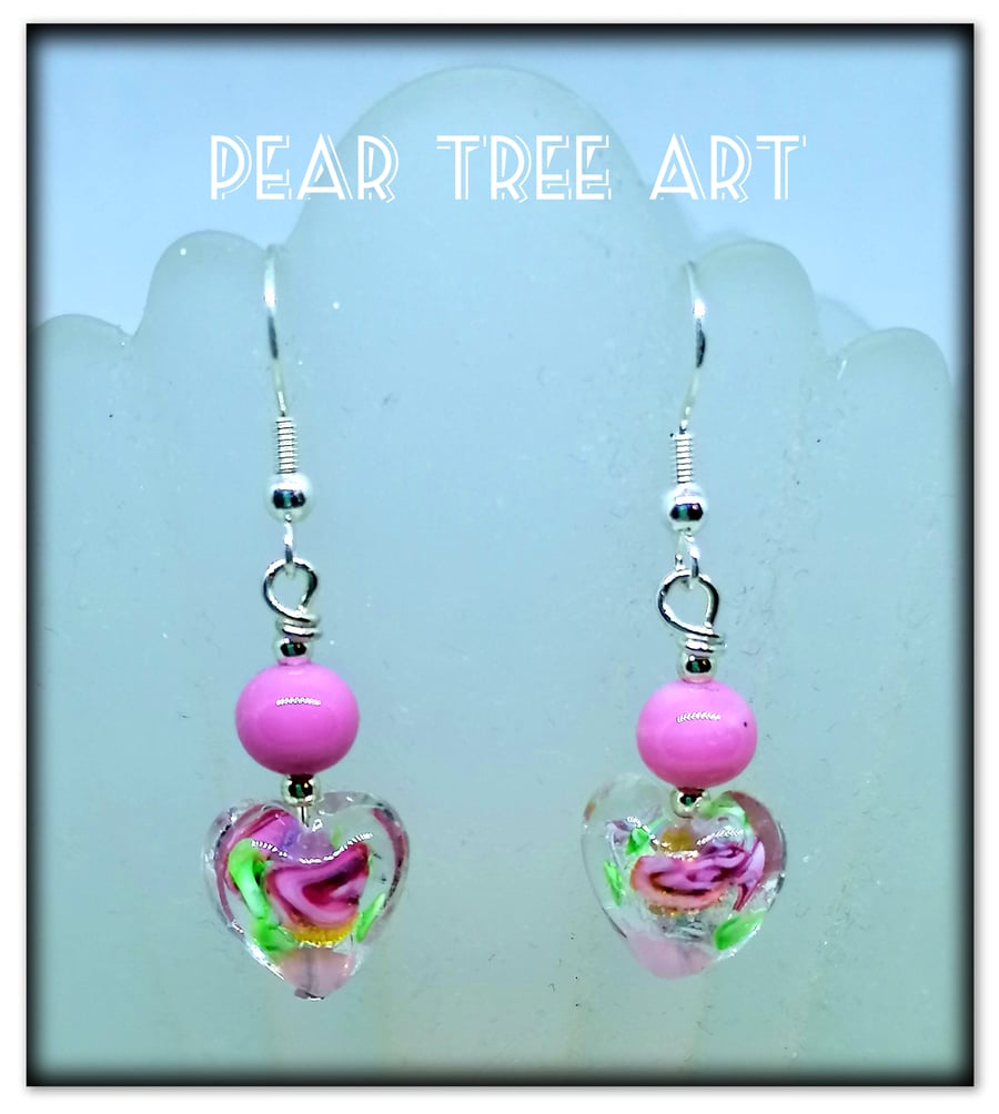 Murano glass pink flower heart drop bead earrings on Silver plated hooks.