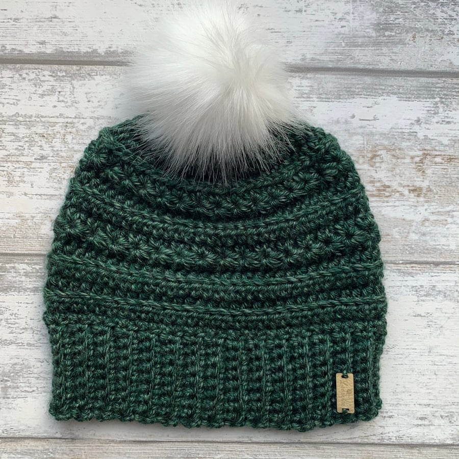 Handmade green crochet beanie hat with white faux fur pompom