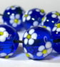 Handmade blue and white daisy patterned lamp work glass beads - Image 1