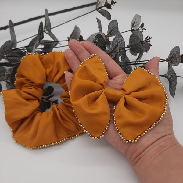 Hair clip on bow and scrunchie set in gold sateen with gold beaded edge. 
