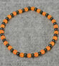 UV Reactive Orange Glass and Dark Metal Bead Elastic Bracelet - Image 4