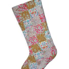 Patchwork stocking made from Liberty Tana Lawn fabric in gold, cream and pink 