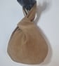 Faux suede brown Japanese knot bag with satin lining.