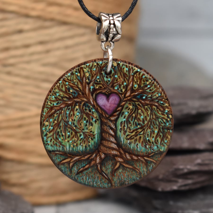 Earthy tree of life with heart. Pyrography round wood pendant.