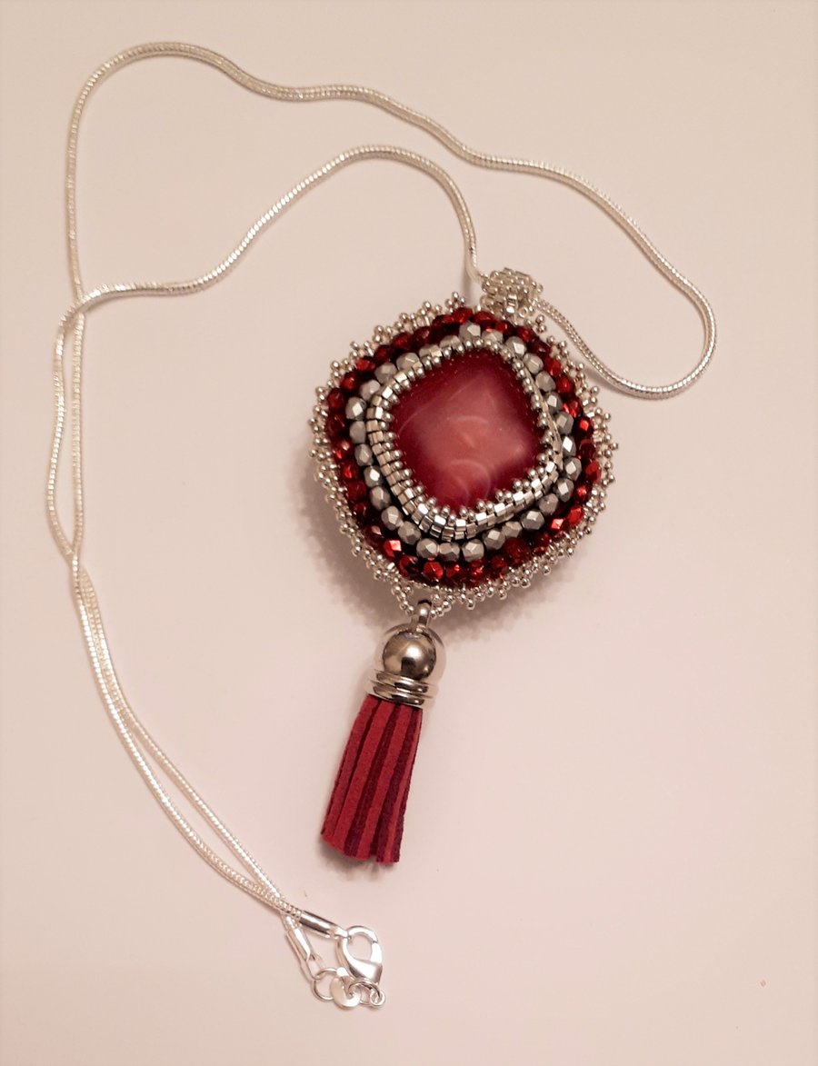 Bead embroidered Red Agate pendant on a silver tone chain   