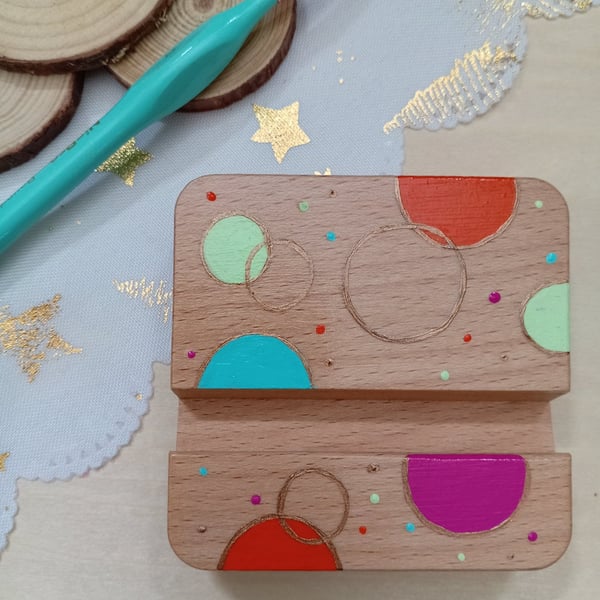 Hand painted circular patterned wooden phone stand 