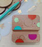 Hand painted circular patterned wooden phone stand 