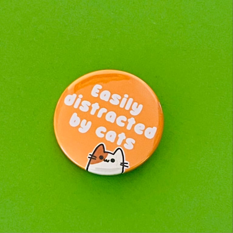 Easily distracted by cats badge, pocket pebble, magnet or keyring.