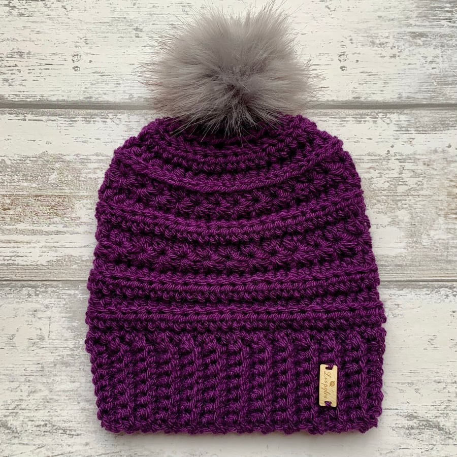 Handmade aubergine purple crochet beanie hat with faux fur pompom