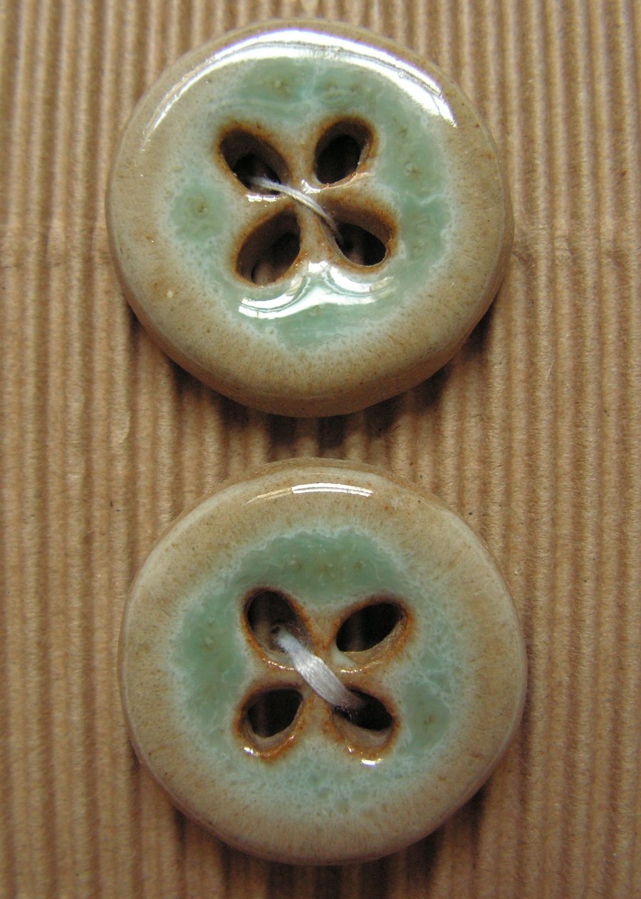 2 ceramic circular blue and brown buttons