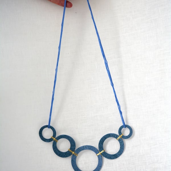Blue porcelain with green speckles necklace with gold colour plated wire