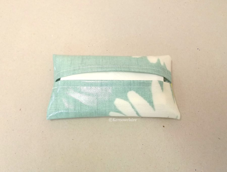 Tissue holder in turquoise oilcloth with a daisy pattern, tissues included