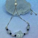 Silver plated slider bracelet with white quartz star and black spinel stones