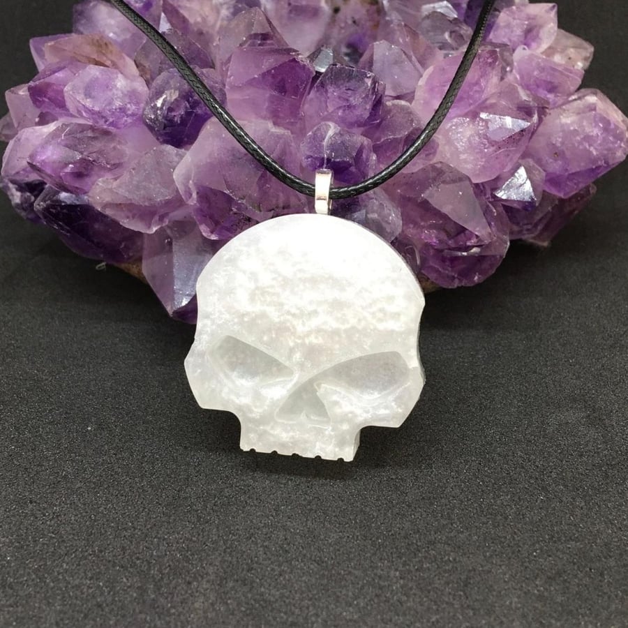 Skull pendant with black cord chain.