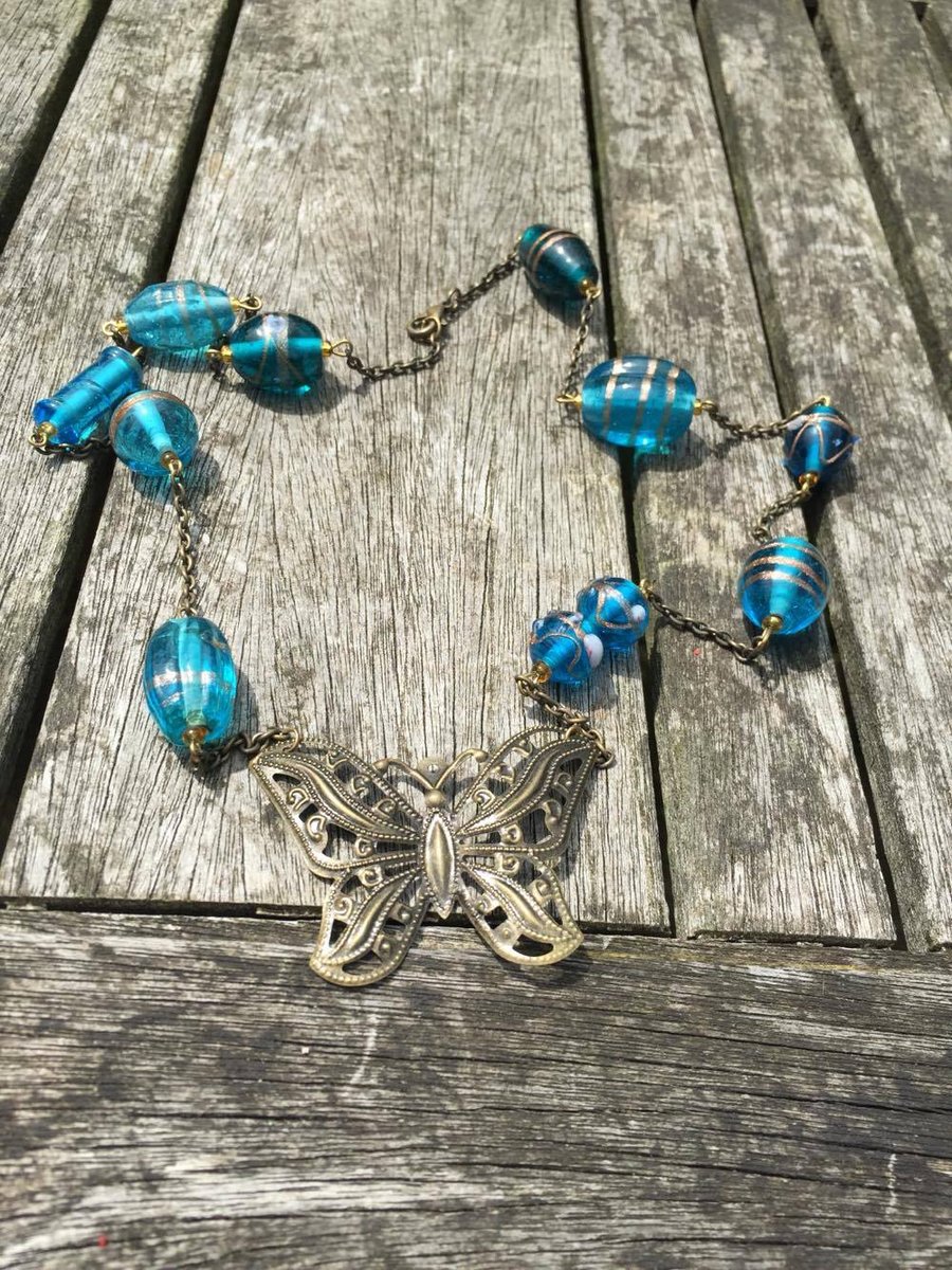 Blue glass beads and antique gold butterfly necklace