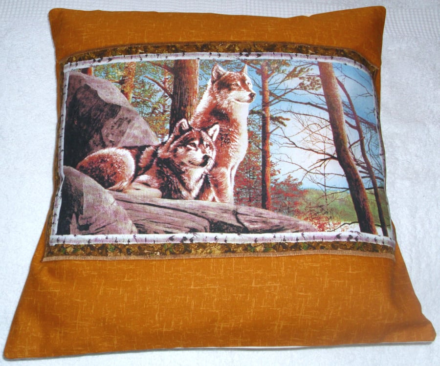 Wolves sitting up on a rocky ledge in Autumn cushion